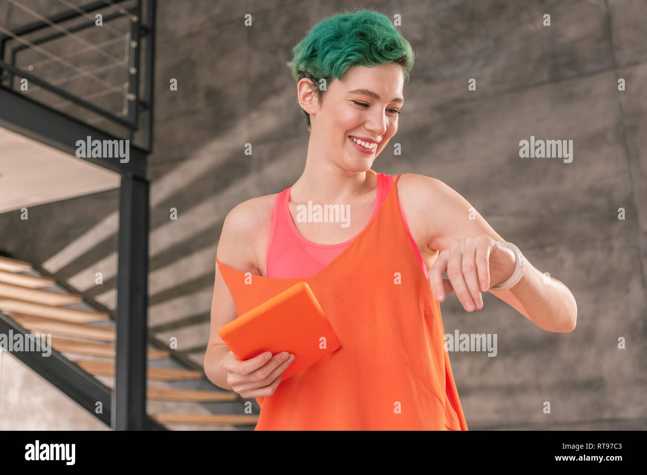 Active woman looking at day activity on her smart watch Stock Photo