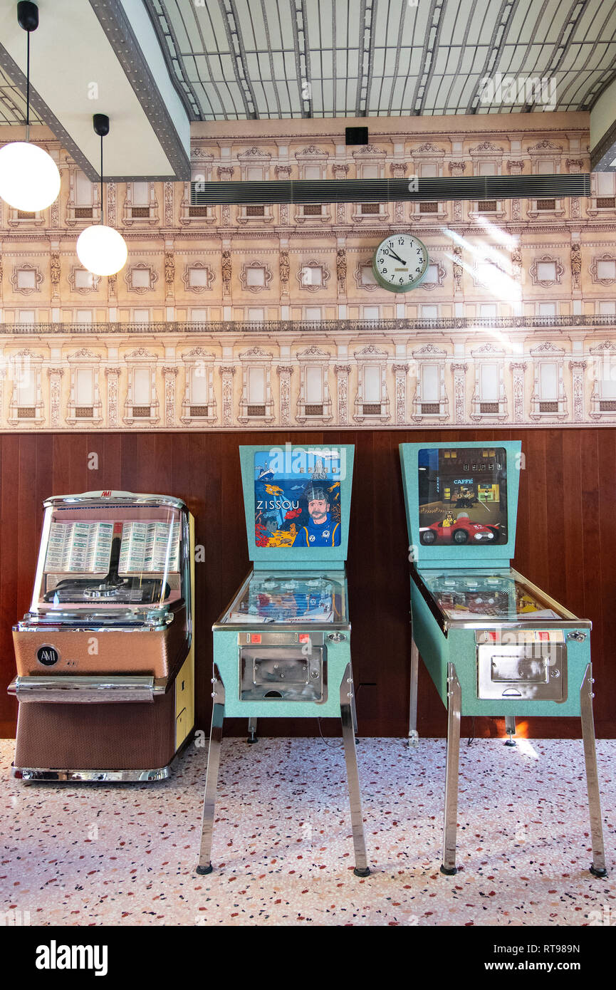 Pinball machines, juke box and retro wallpaper at Bar Luce, Wes Anderson-inspired bar and cafe in the Fondazione Prada district of Milan, Italy Stock Photo