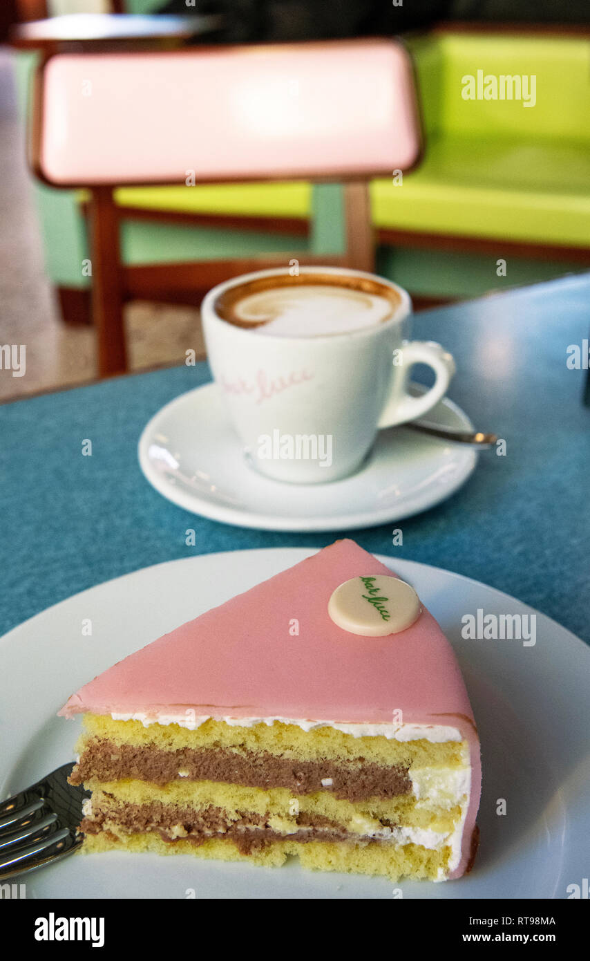 Cappuccino, Torta Rosa and pastel furniture at Bar Luce, Wes Anderson-inspired bar and cafe in the Fondazione Prada district of Milan, Italy Stock Photo