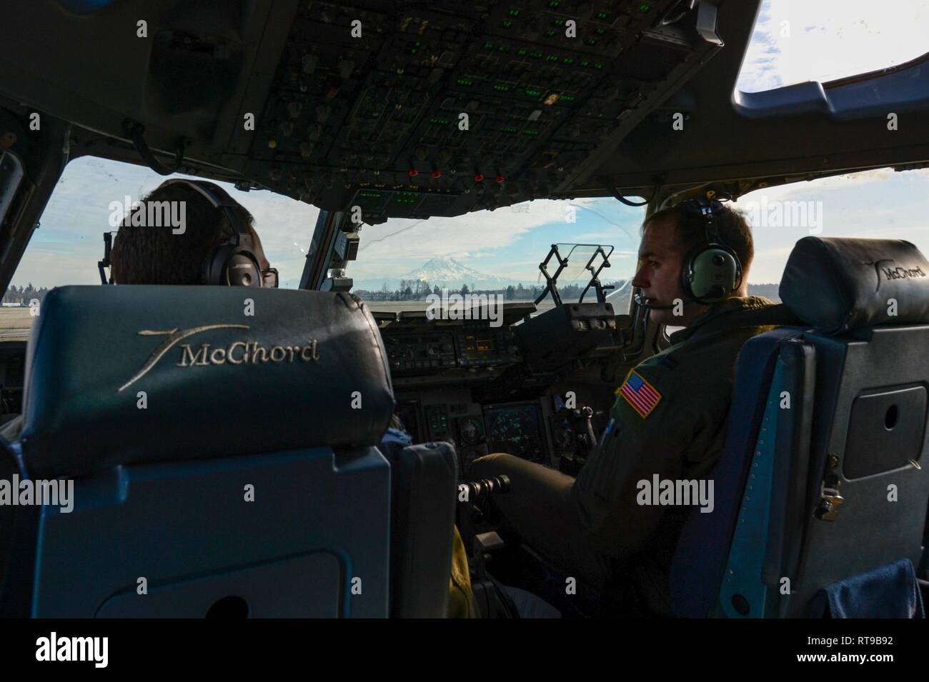Capt. Wade Gallup, right, and Capt. Ryan Arsenault, 7th Airlift Squadron pilots, prepare to take off at McChord Field, Wash., Jan. 30, 2019. The pilots were part of a crew training to refuel from the KC-46 Pegasus. Stock Photo