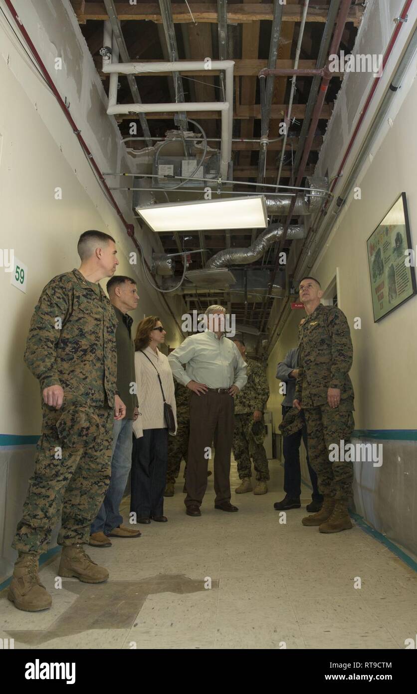 Distinguished guests assess damage to the interior of the II Marine Expeditionary Force headquarters building during a tour on Marine Corps Base Camp Lejeune, N.C., Jan 26, 2019. Lt. Gen. John M. Jansen visited MCB Camp Lejeune and Marine Corps Air Station New River to assess Hurricane Florence-related damage and ongoing restoration efforts. Stock Photo