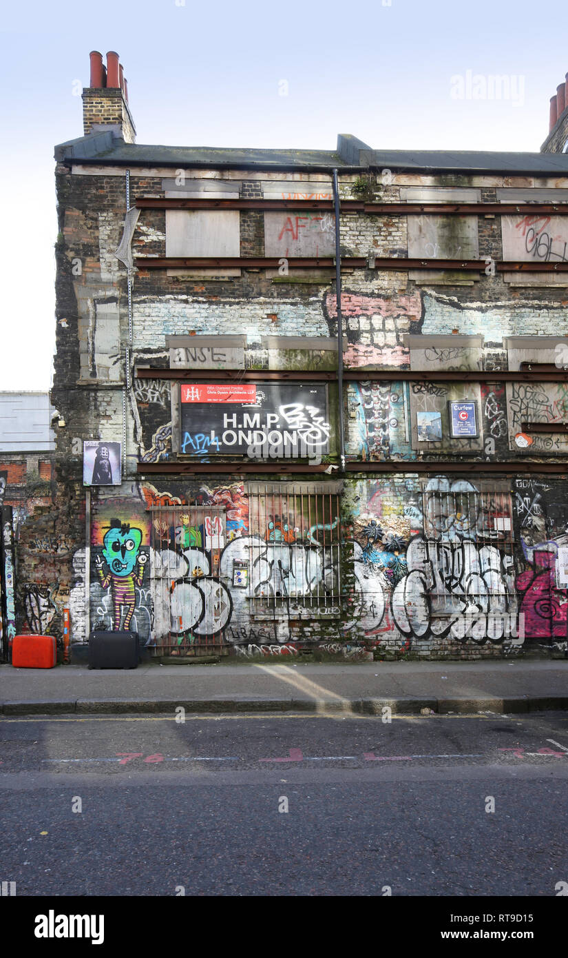 Graffiti on the side of a derelict building in London's Shoreditch area, UK. Architects board suggests redevelopment plans in this now trendy area. Stock Photo