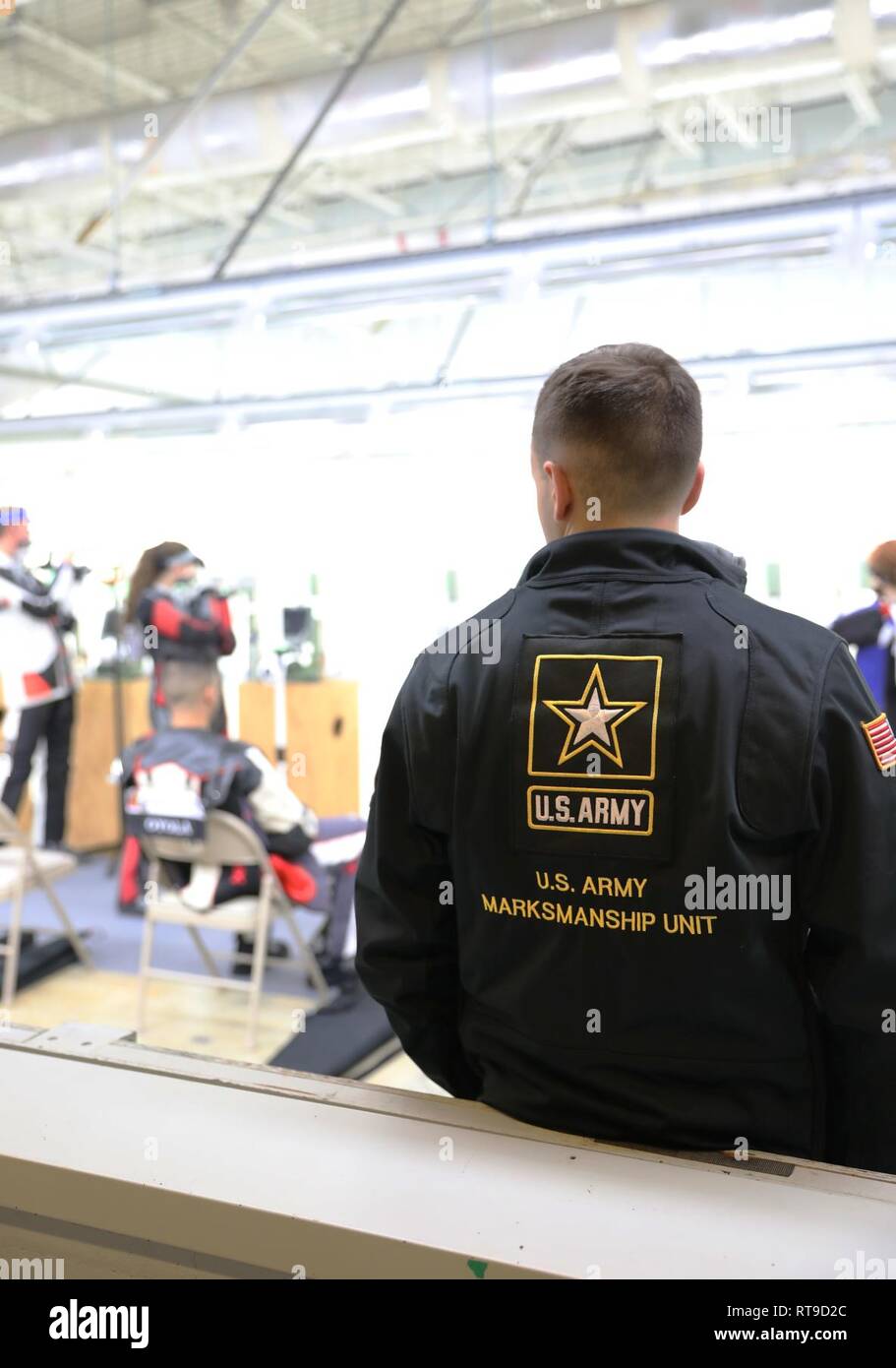 U.S. Army Pfc. Jared Desrosiers, a Swansea, Massachusetts native who serves on the U.S. Army Marksmanship Unit’s International Rifle Team, watches over competitors at the U.S. Army Junior Rifle National Championships at Fort Benning, Georgia January 26, 2019. The three-day, invitation-only event had the youth athletes compete side by side for top individual and team honors in three-position smallbore, sporter rifle and precision rifle. Stock Photo