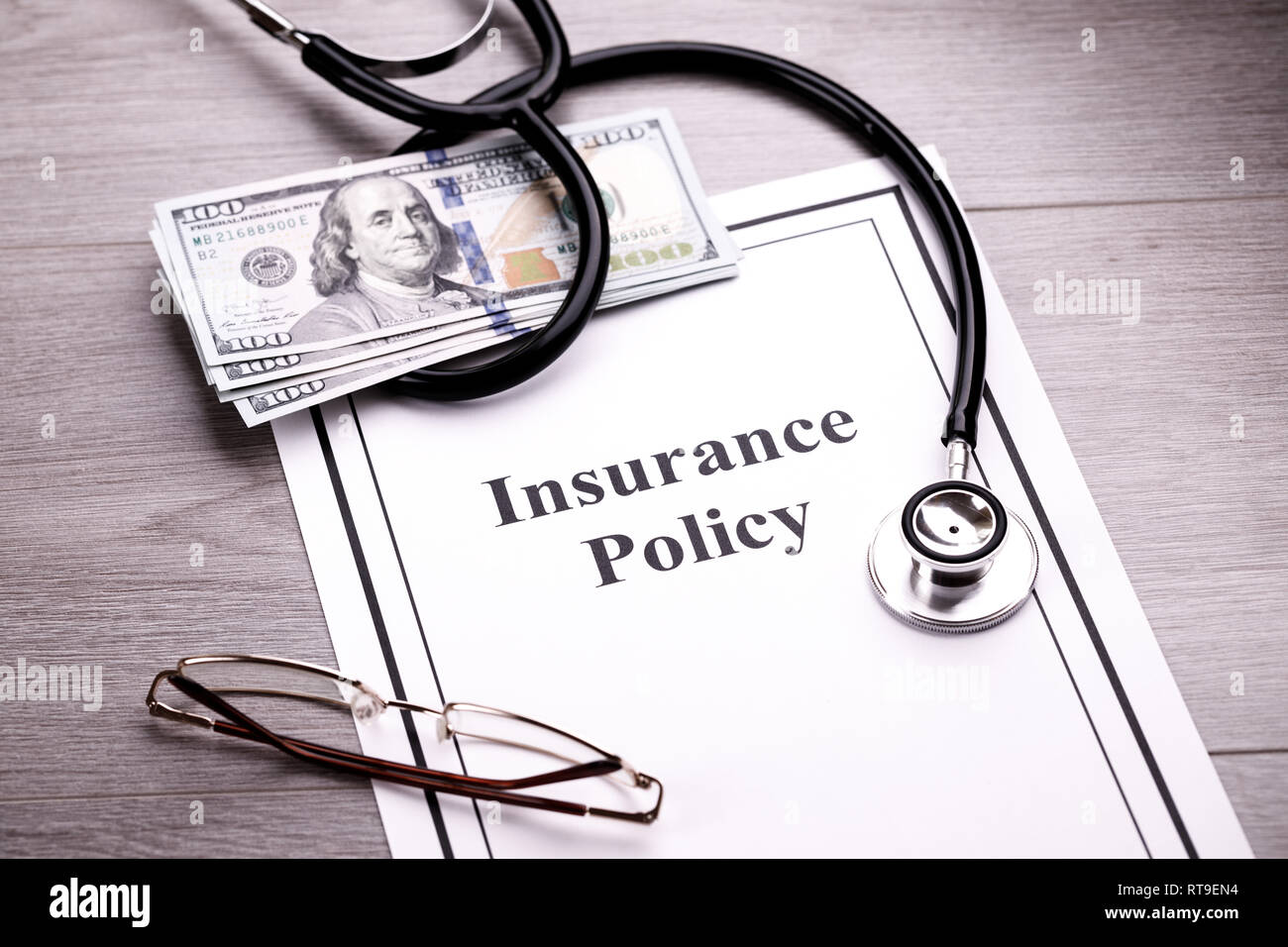 Health Insurance Policy. Stethoscope, Glasses and Dollars Stock Photo
