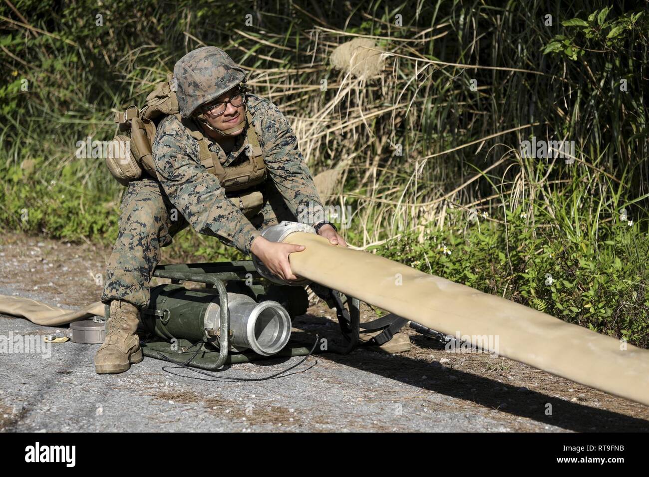 Pfc. Gilberto Loza-Machado pulls on a fuel hose to be attached to a meter  on Jan. 28, 2019 at Central Training Area, Camp Hansen, Okinawa, Japan.  Marines with 2nd Platoon, Bulk Fuel