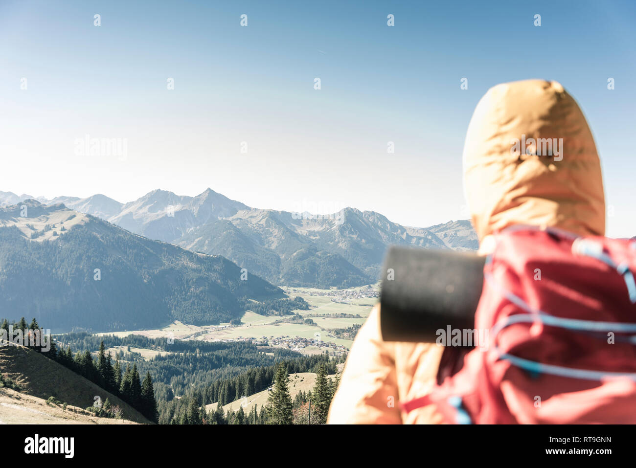 Austria, Tyrol, rear view of man on a hiking trip in the mountains enjoying the view Stock Photo