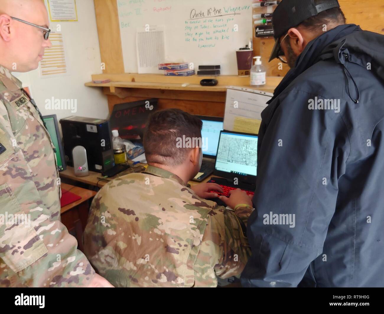 Staff Sgt. Richard Bowen and Pfc. Eric Lopez, 869th Movement Control Team, getting trained on the new Global Distribution Management System (GDMS) at the Baghdad Diplomatic Support Center, Iraq, Jan. 29, 2019. Stock Photo