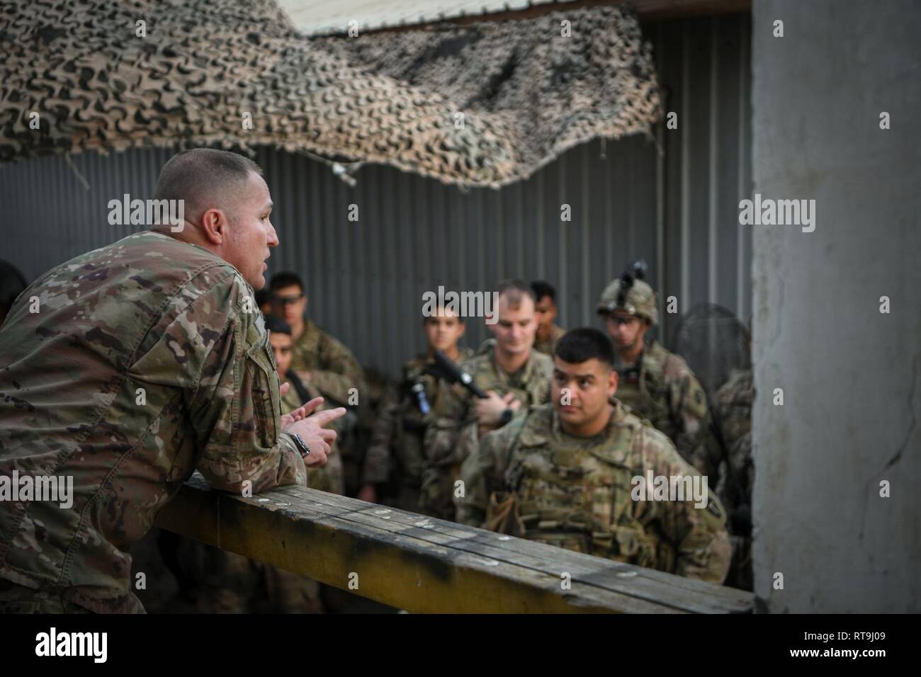 U.S. Army Capt. Raymond Bayane, commanding officer of Delta Company, 1st Battalion, 141st Infantry Regiment (1-141 IN), Texas Army National Guard, deployed in support of Combined Joint Task Force - Horn of Africa (CJTF-HOA), briefs his Soldiers in the reaction force compound on Camp Lemonnier, Djibouti, Jan. 29, 2019. The mission of the 1-141 IN is to rapidly deploy in response to any crisis threatening U.S. personnel or property throughout CJTF-HOA, and to contribute to international efforts to enhance security and stability in East Africa by providing security force assistance and fostering  Stock Photo