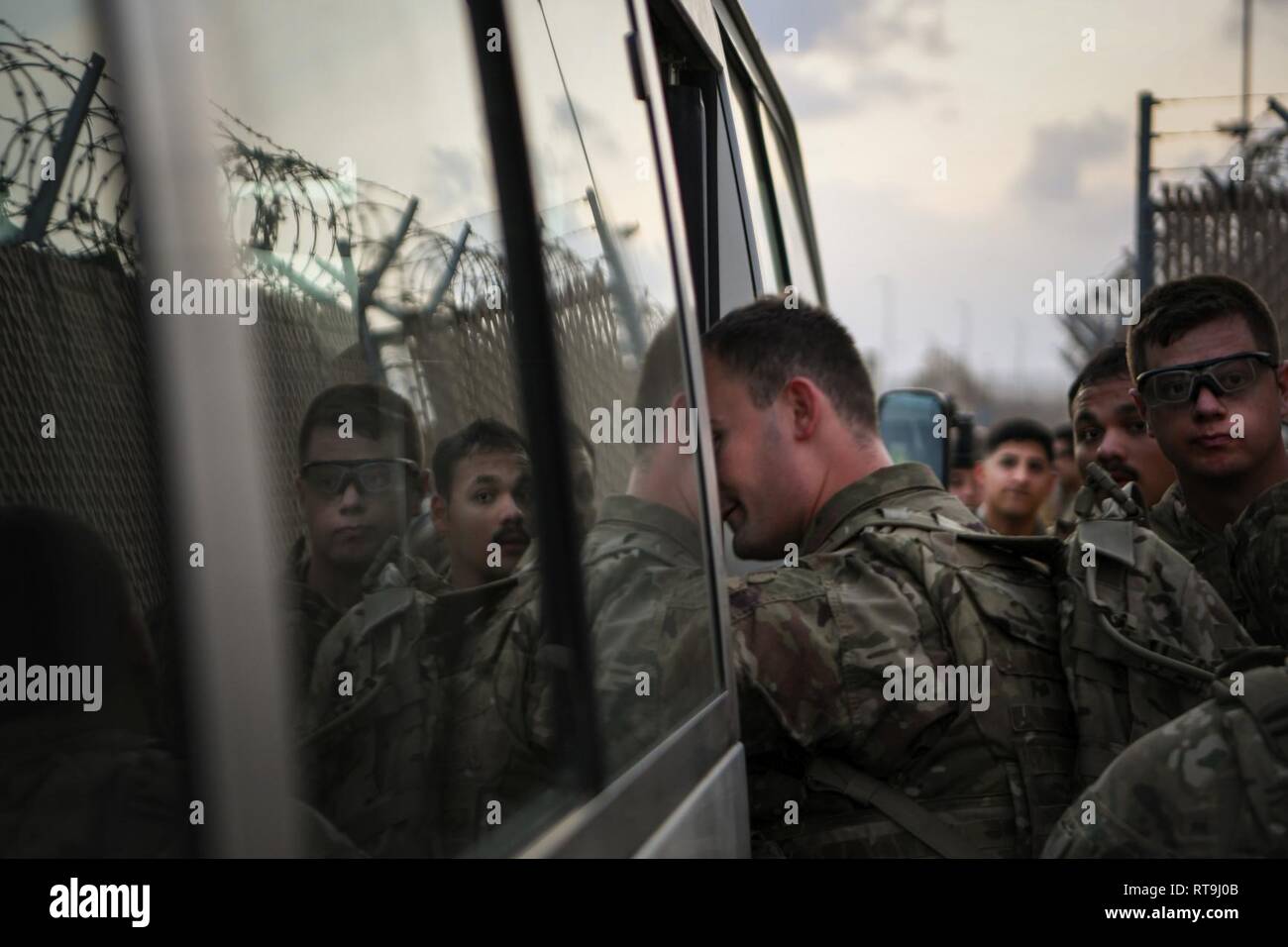 U.S. Soldiers with Delta Company, 1st Battalion, 141st Infantry Regiment (1-141 IN), Texas Army National Guard, deployed in support of Combined Joint Task Force - Horn of Africa (CJTF-HOA), load a bus in preparation for training from the reaction force compound on Camp Lemonnier, Djibouti, Jan. 29, 2019. The mission of the 1-141 IN is to rapidly deploy in response to any crisis threatening U.S. personnel or property throughout CJTF-HOA, and to contribute to international efforts to enhance security and stability in East Africa by providing security force assistance and fostering the capabiliti Stock Photo