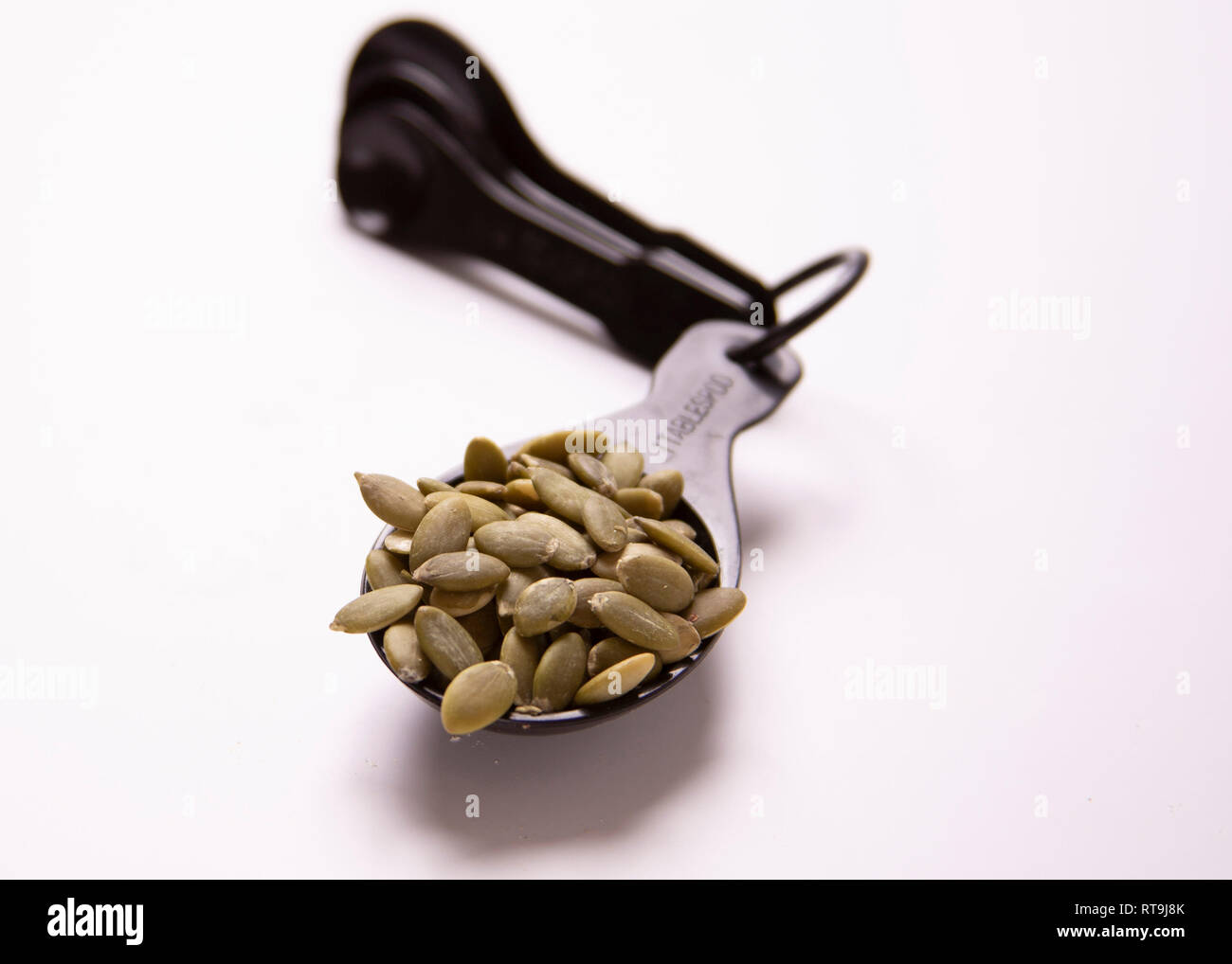 One tablespoon of food. Portion control. Pumpkin seeds Stock Photo Alamy