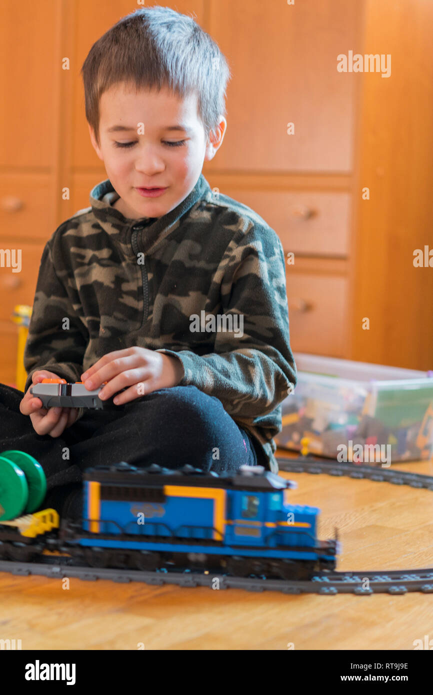Little boy playing with a toy railway. Little boy playing with railway ...