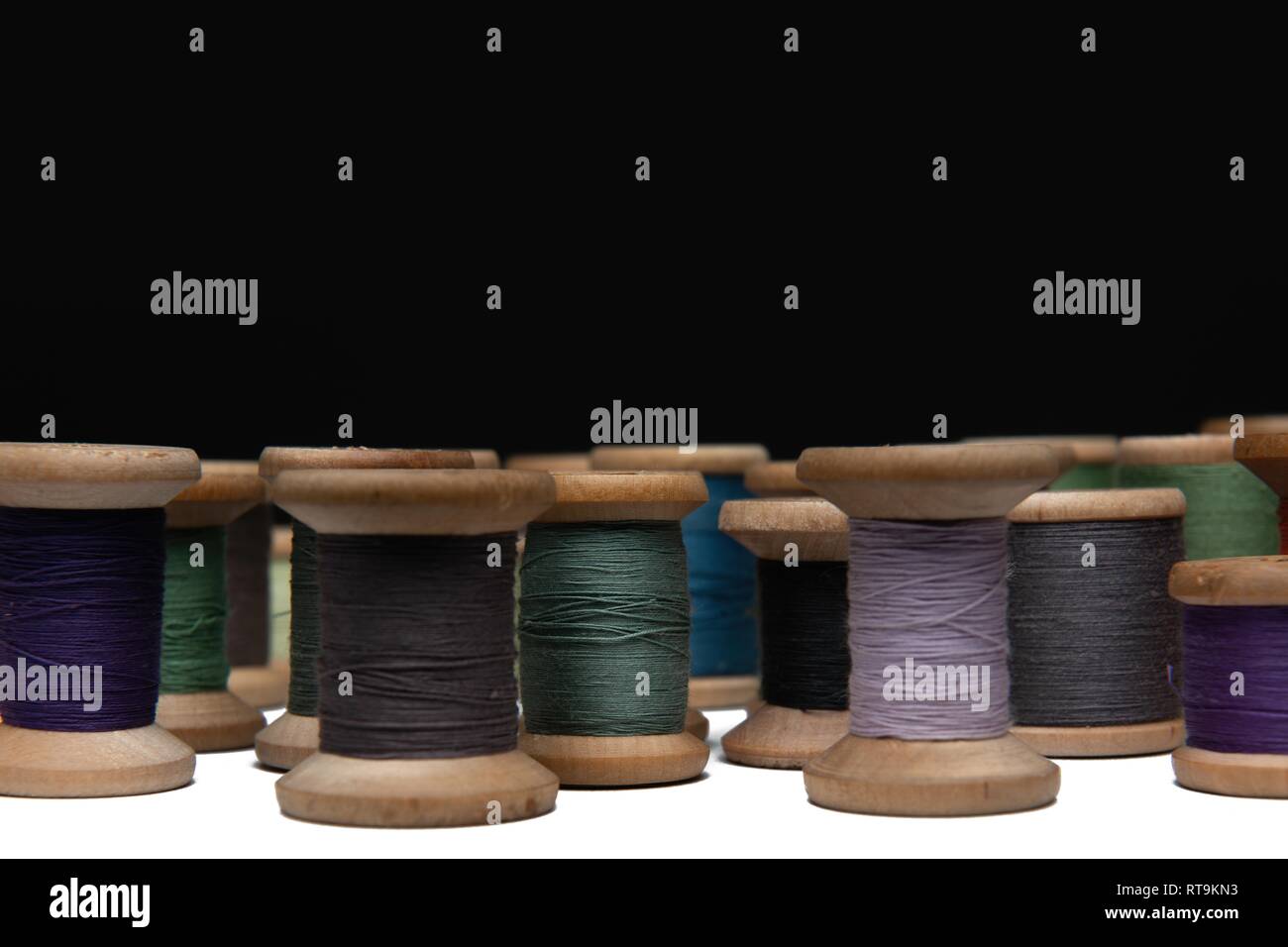 wooden coils with colorful threads of pastel colors Stock Photo