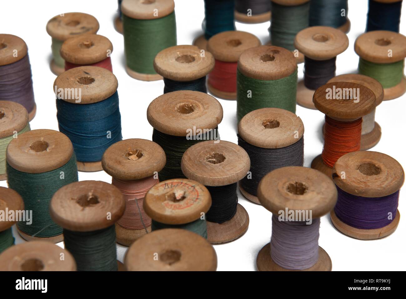 wooden coils with colorful threads of pastel colors Stock Photo