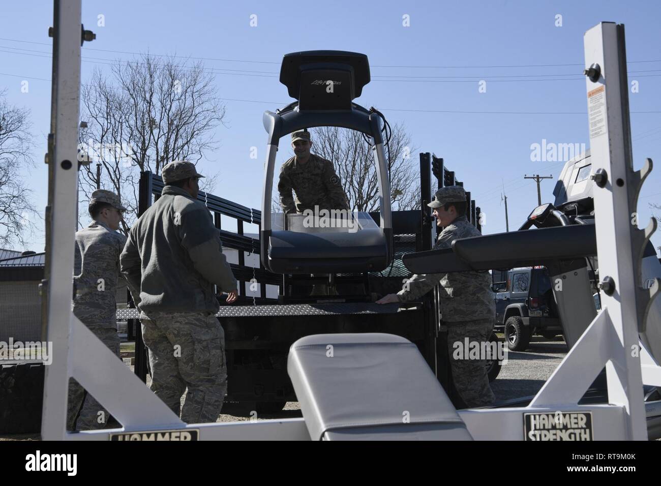 Members of 4th Operations Support Squadron unload a treadmill for the 4th OSS Unit Physical Training Facility on Jan. 31, 2019, at Seymour Johnson Air Force Base, North Carolina. Satellite gyms around the base acquired the outgoing gym equipment from the 4th Force Support Squadron fitness center. Stock Photo