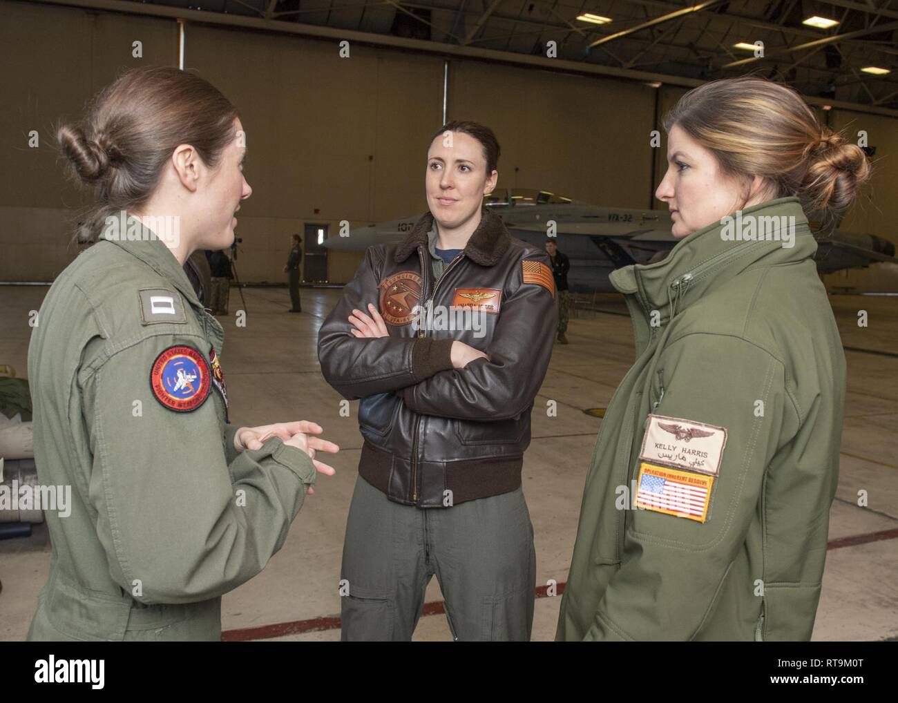 NAVAL AIR STATION OCEANA (Jan. 31, 2019) Lt. Emily Rixey, left, Lt. Amanda  Lee, middle, and Lt. Kelly Harris, right, talk to each other in a hangar  bay on Naval Station Oceana.