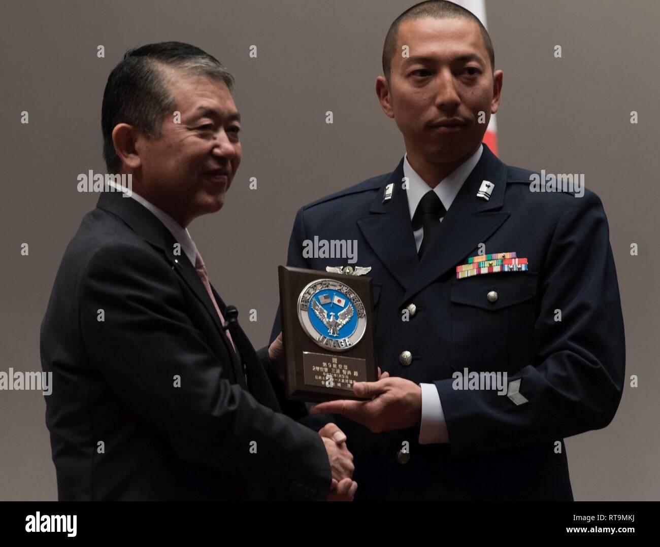 Japan Air Self-Defense Force Tech. Sgt. Tomonori Miura, 9th Air Wing Armament Maintenance Squadron munitions troop, receives an award from Mr. Shigeru Iwasaki, Japan-America Air Force Goodwill Association president, during the 2018 JAAGA Awards Ceremony January 31, 2019, at Naha Air Base, Japan. Miura was recognized for his outstanding skills as a munitions troop. During a bilateral exchange, Miura learned about mobility maintenance at Kadena Air Base and participated in a bilateral exercise. Stock Photo