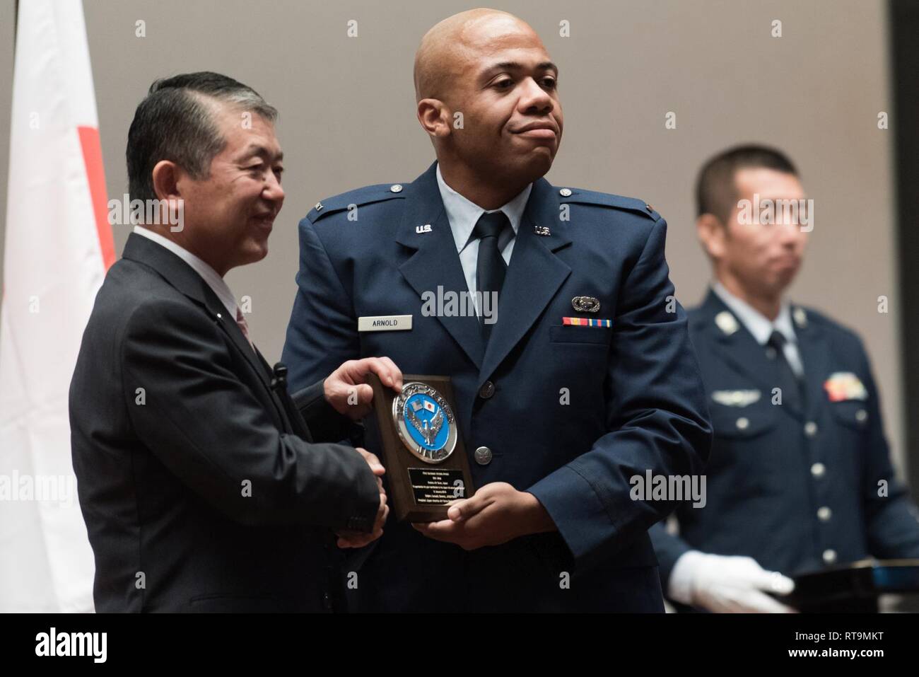 U.S. Air Force 1st Lt. Antoinio Arnold, 18th Operation Support Squadron chief of intel readiness, receives an award from Mr. Shigeru Iwasaki, Japan-America Air Force Goodwill Association president, during the 2018 JAAGA Awards Ceremony January 31, 2019, at Naha Air Base, Japan. Arnold was recognized for his outstanding skills in a Japan-U.S. defense conference, the Bilateral Leadership Officer Group and the Koku-Jieitai English Competition. Stock Photo