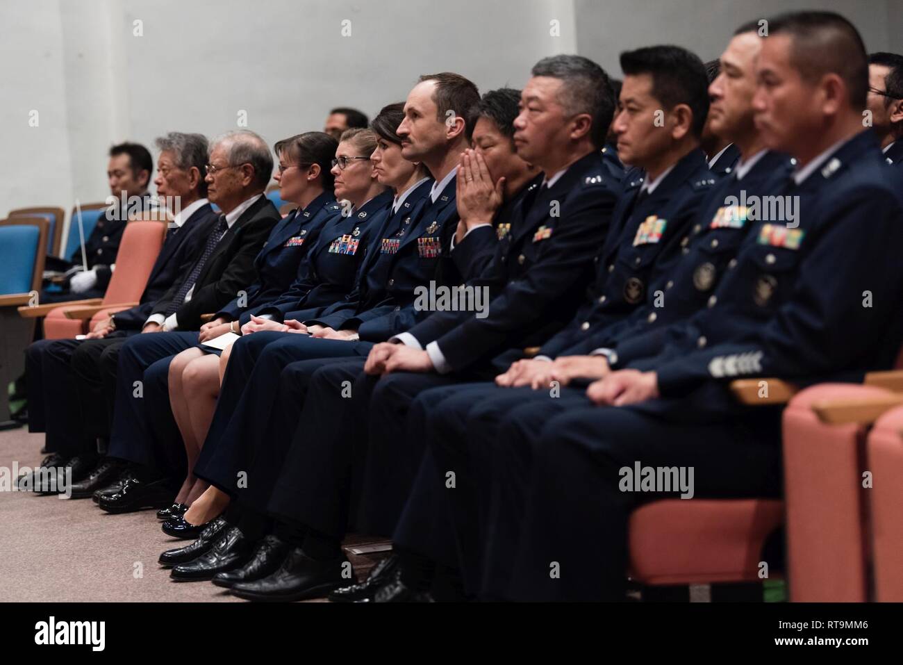 Airmen from the Japan Air Self-Defense Force’s Naha Air Base and U.S. Air Force’s 18th Wing sit side-by-side with Japan-America Air Force Goodwill Association members during the 2018 JAAGA Awards Ceremony January 31, 2019, at Naha Air Base, Japan. JAAGA promotes friendly and cooperative relationships between the JASDF and U.S. Air Force. Stock Photo