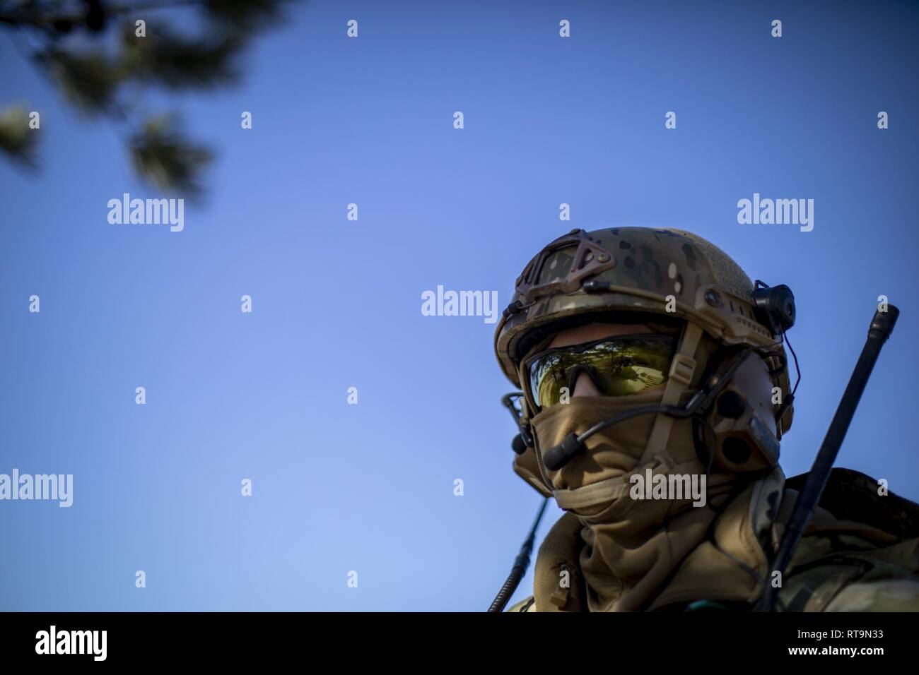 U.S. Air Force Staff Sgt. Michael Bradley, a Tactical Air Control Party Airman with the New Jersey Air National Guard’s 227th Air Support Operations Squadron, watches as fellow Airmen prepare gear for close air support training on Warren Grove Range, N.J., Jan. 31, 2019. The New Jersey Airmen trained with A-10C Thunderbolt II aircraft from the Maryland Air National Guard’s 104th Fighter Squadron as well as F-16C Fighting Falcons from New Jersey’s own 119th Fighter Squadron despite record low temperatures due to a polar vortex. The polar vortex is shuttling Arctic air across the Northeastern Un Stock Photo