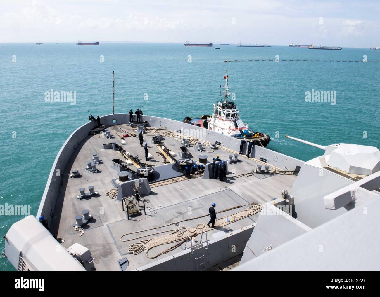 SINGAPORE (Jan. 31, 2019) The San Antonio-class amphibious transport dock ship USS Anchorage (LPD 23) departs Changi Naval Base, Singapore, while on a deployment of the Essex Amphibious Ready Group (ARG) and 13th Marine Expeditionary Unit (MEU). The Essex ARG/13th MEU is a capable and lethal Navy-Marine Corps team deployed to the 7th fleet area of operations to support regional stability, reassure partners and allies and maintain a presence postured to respond to any crisis ranging from humanitarian assistance to contingency operations. Stock Photo