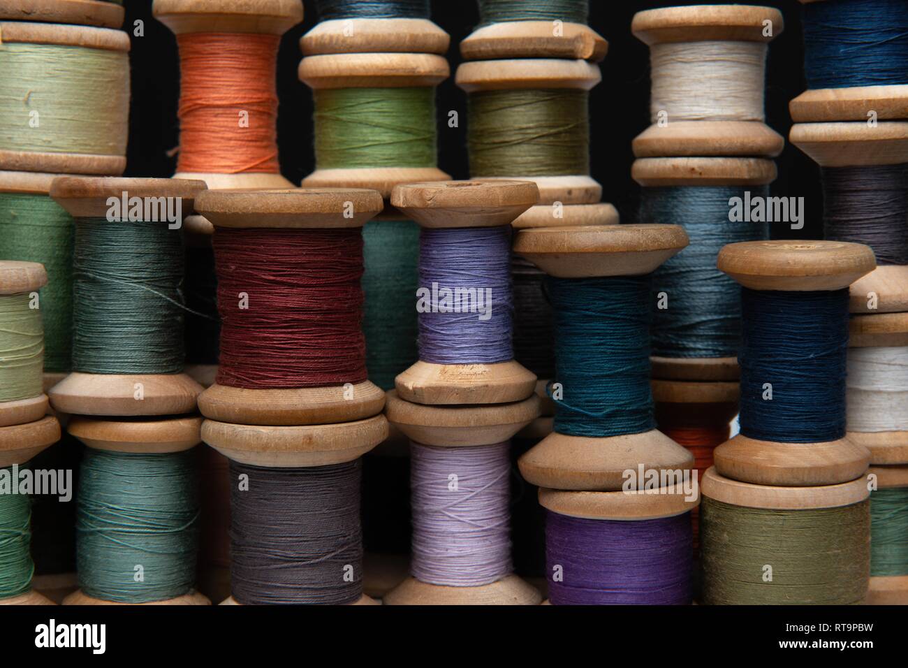 wooden coils with colorful threads of pastel colors Stock Photo