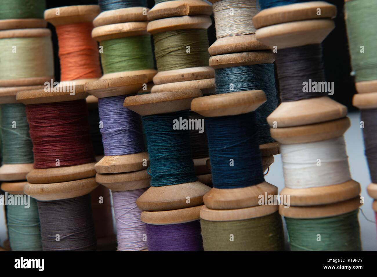 wooden coils with colorful threads of pastel colors Stock Photo Alamy