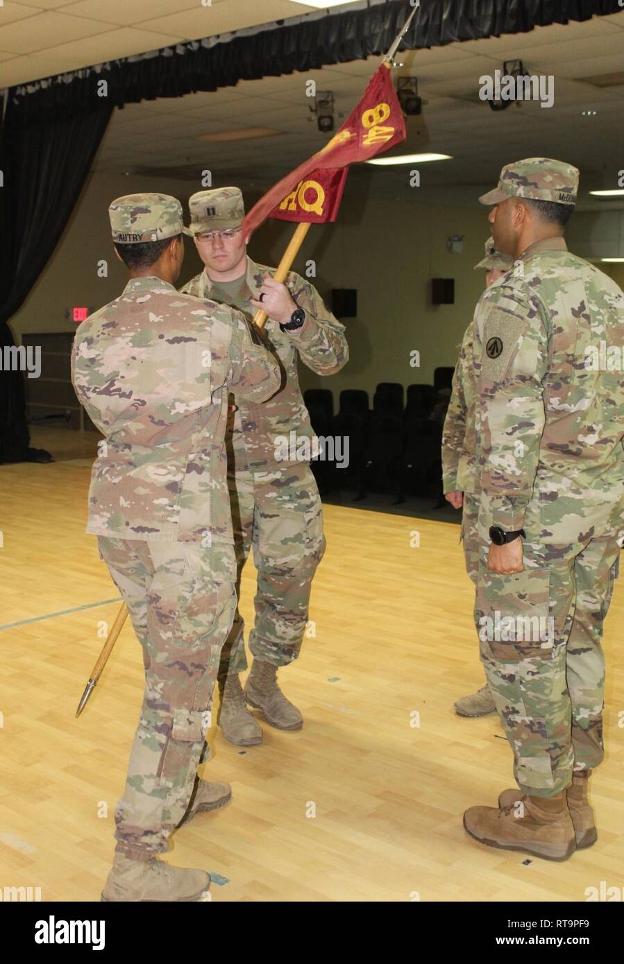 Capt. Willard C. Lewman receives the guidon from Sgt. 1st Class Stacy C. Autry during a change of command ceremony for Headquarters & Headquarters Detachment, 840th Transportation Battalion, at Camp Arifjan, Kuwait, Jan. 31, 2019. Stock Photo
