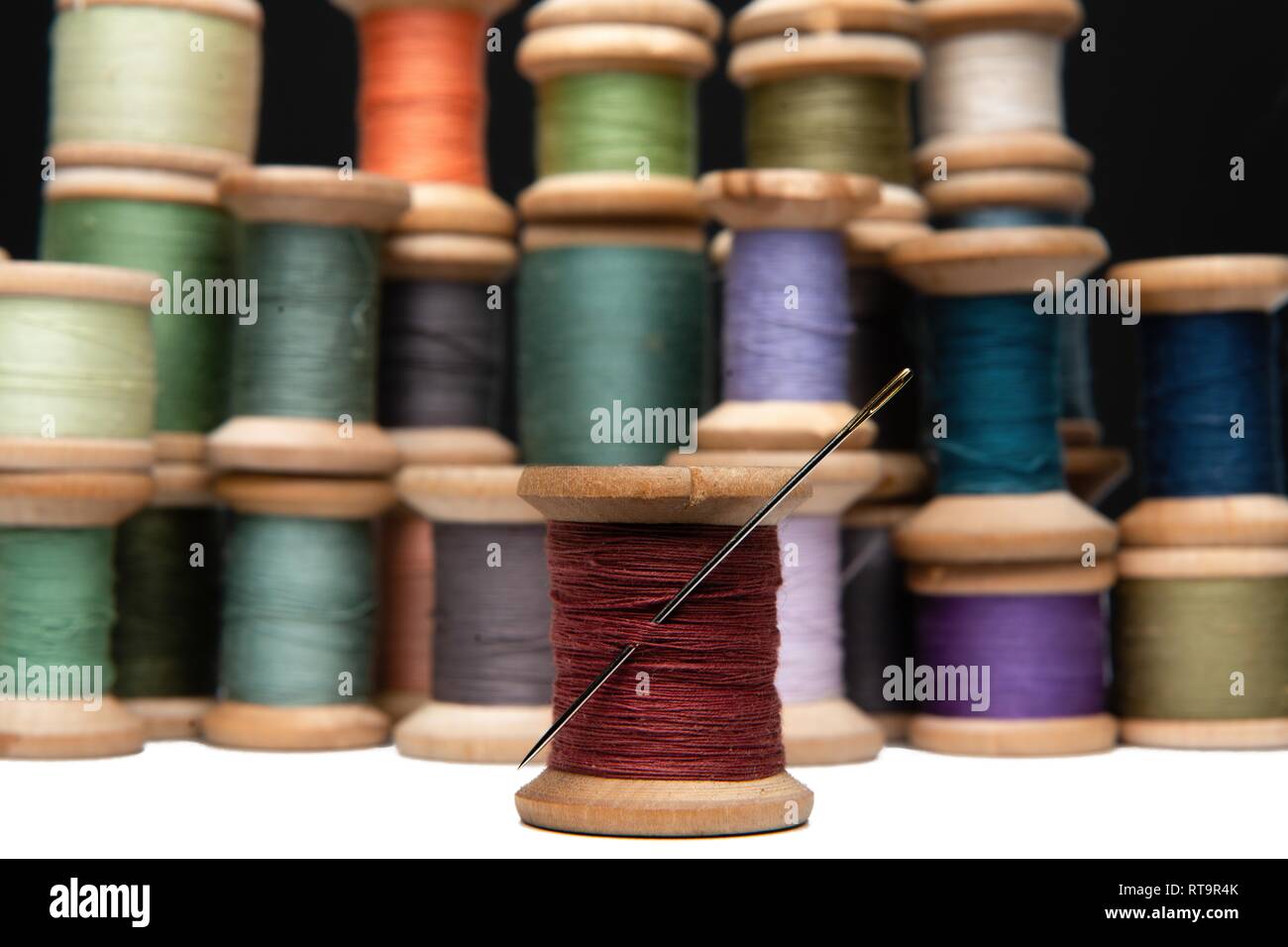 wooden coils with colorful threads of pastel colors Stock Photo