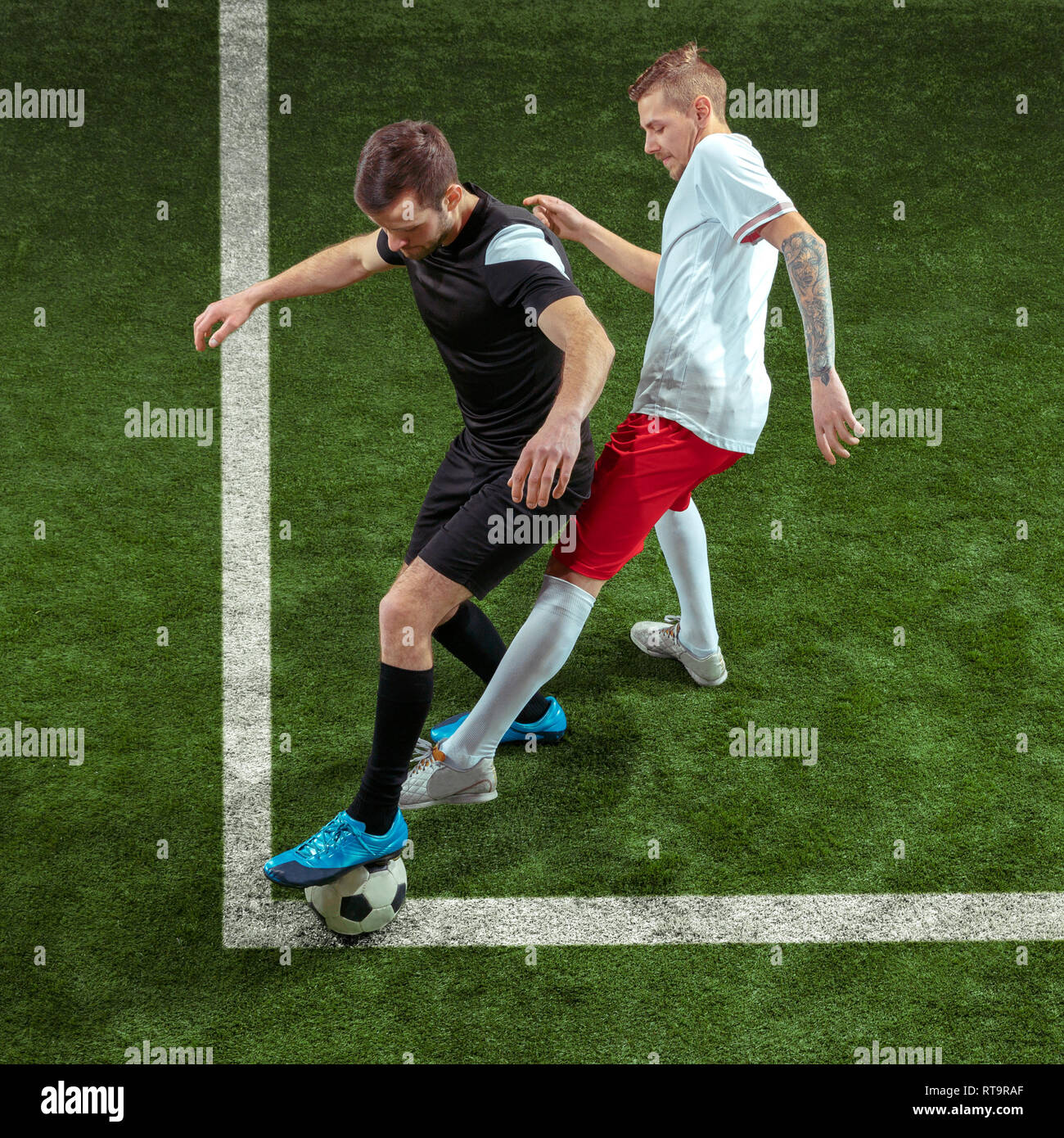 Professional football or soccer player in action on stadium with