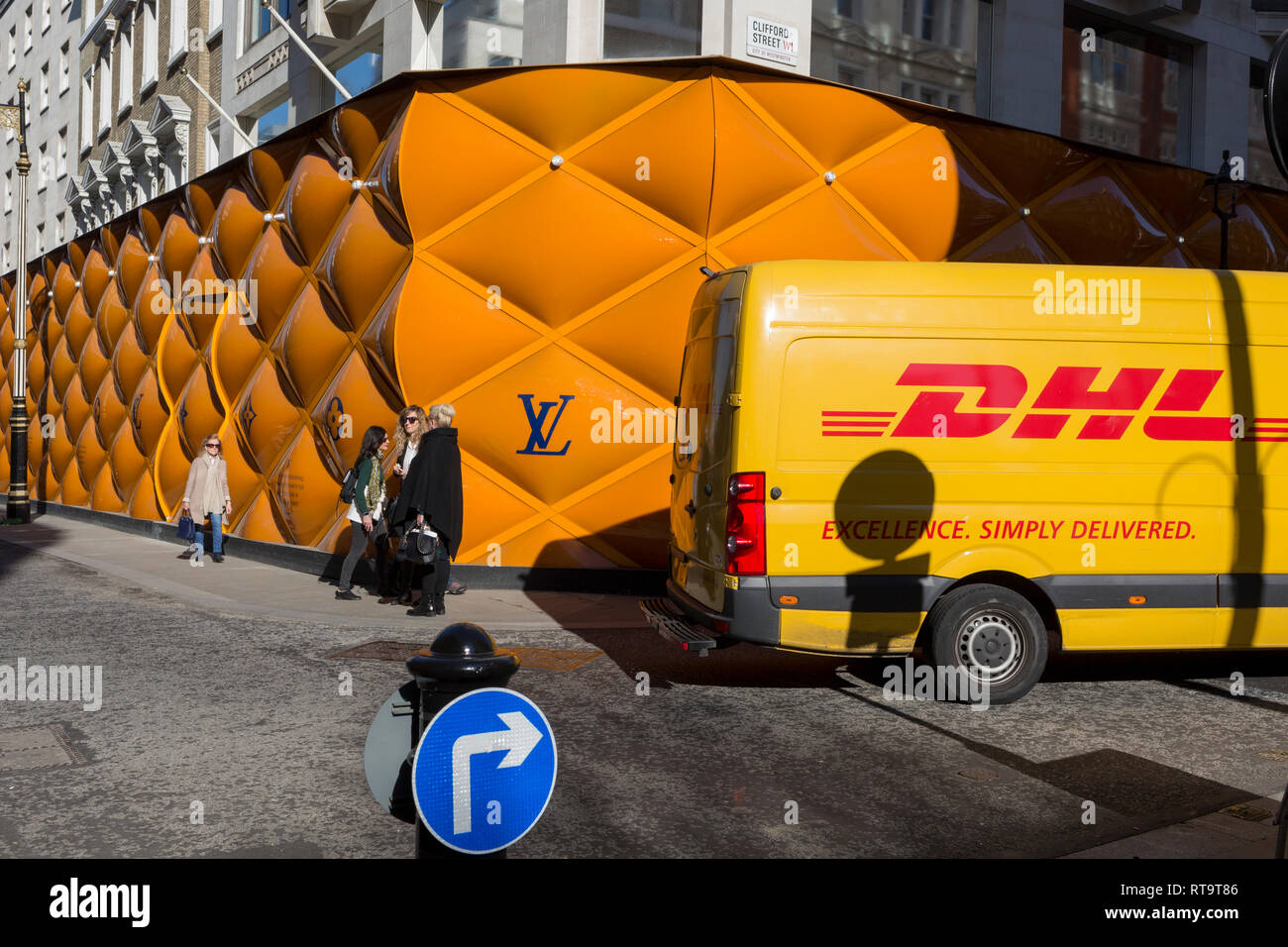 A DHL delivery courier van drives past the temporary renovation hoarding of  luxury brand Louis Vuitton in New Bond Street, on 25th February 2019, in  London, England Stock Photo - Alamy