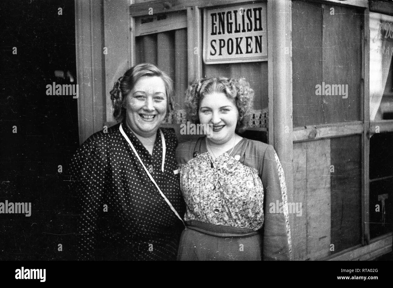 Bar cafe owners with English spoken sign on their cafe in Brussels Belgium September 1944 after liberation from the Germans during WW2 Stock Photo