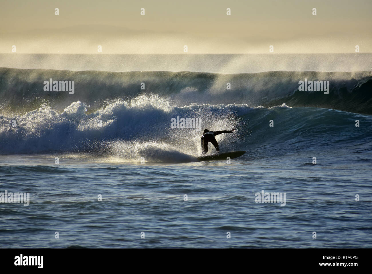 Surfers on the atlantic ocean waves in la pared on fuerteventura canary islands in spain Stock Photo
