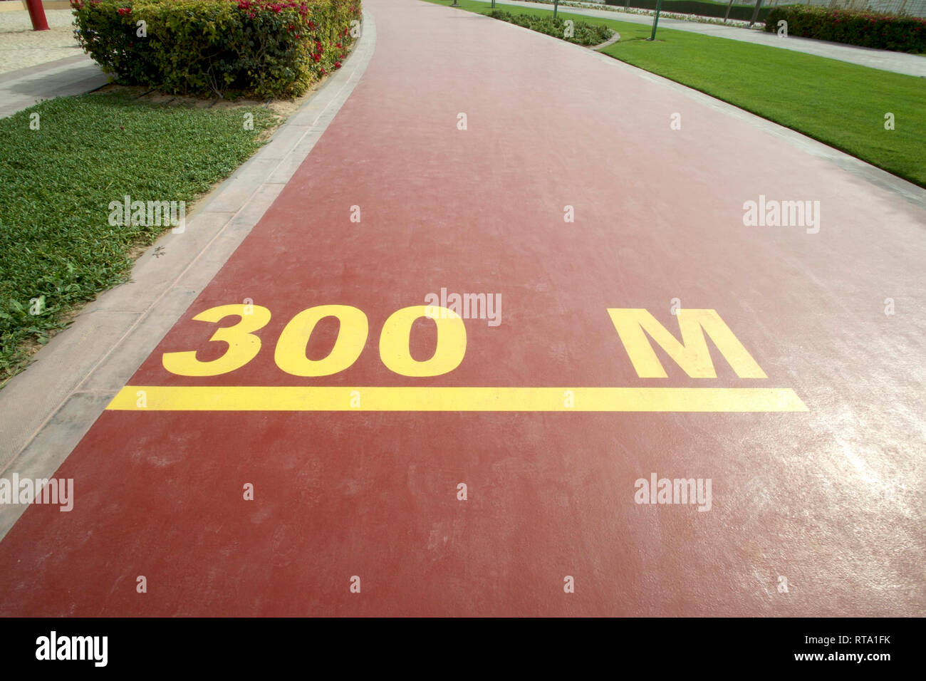 Dubai-Al Barsha Pond Park running track mark 300 M narrow Stock Photo