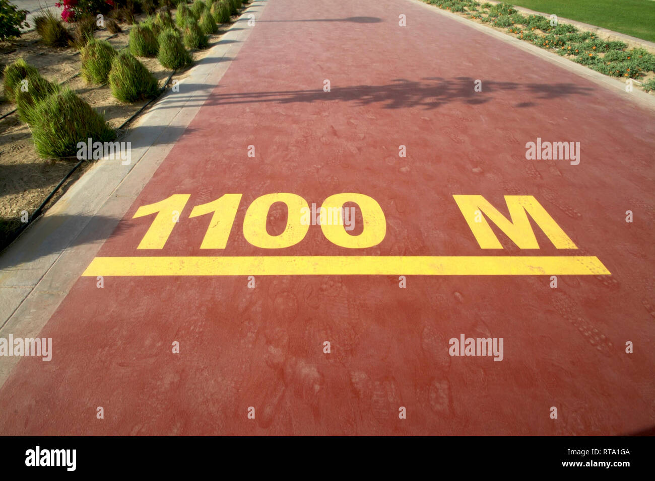 Dubai-Al Barsha Pond Park running track mark 1100 M narrow Stock Photo