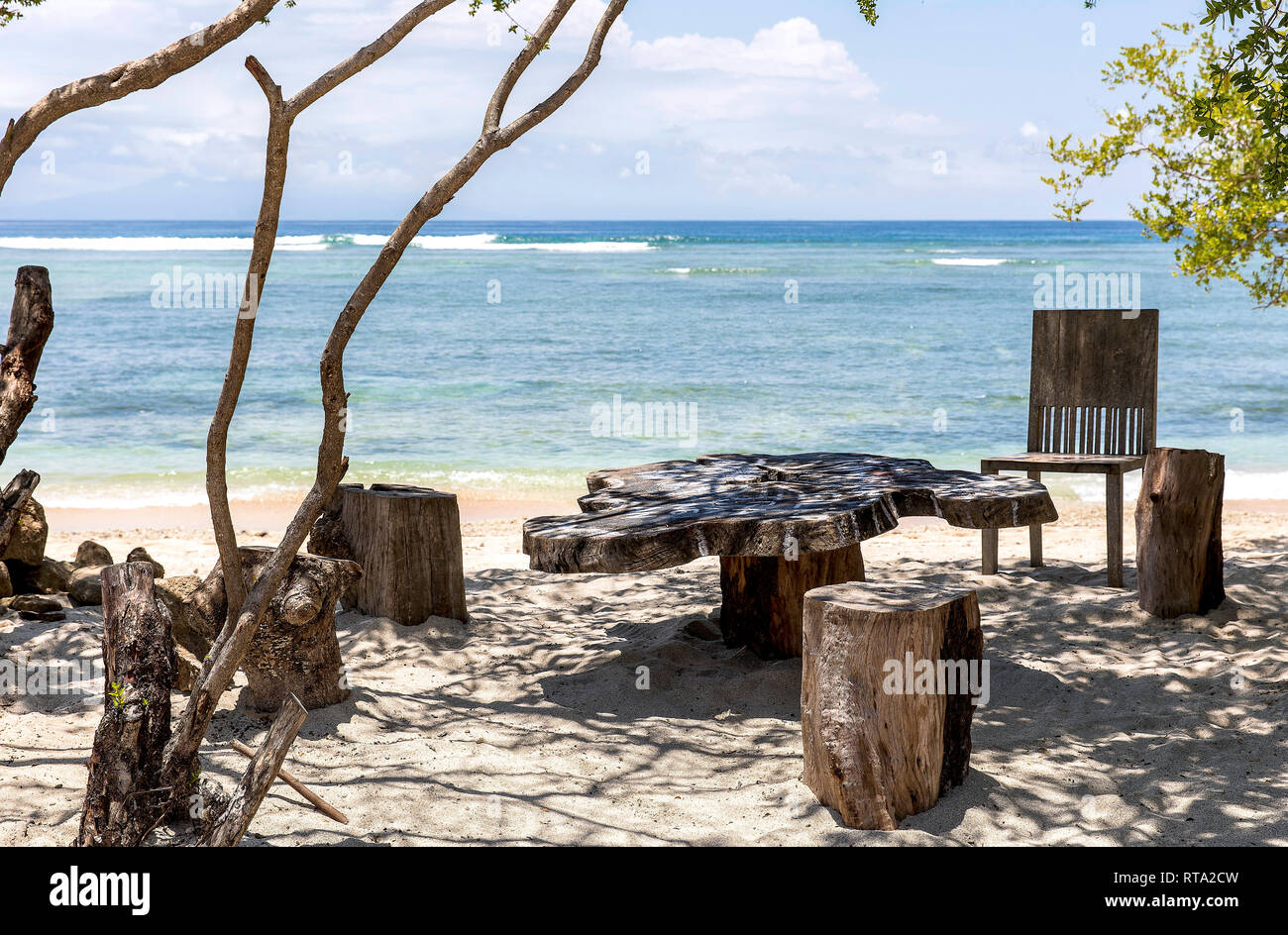Wooden seating groups on the beach of Gili Trawangan, Indonesia. Stock Photo
