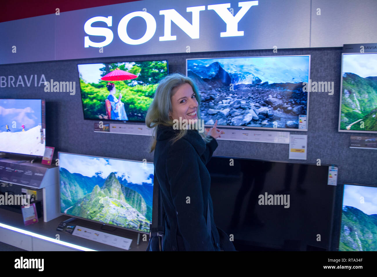 10 February 2019-Buicharest, Romania. A woman looking at the TV's to buy one. Stock Photo