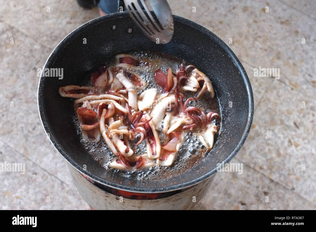Squid with garlic and pepper in pan . Thai food Stock Photo