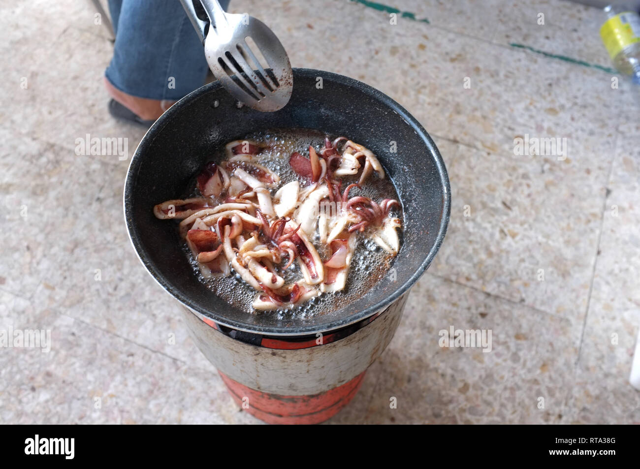 Squid with garlic and pepper in pan . Thai food Stock Photo