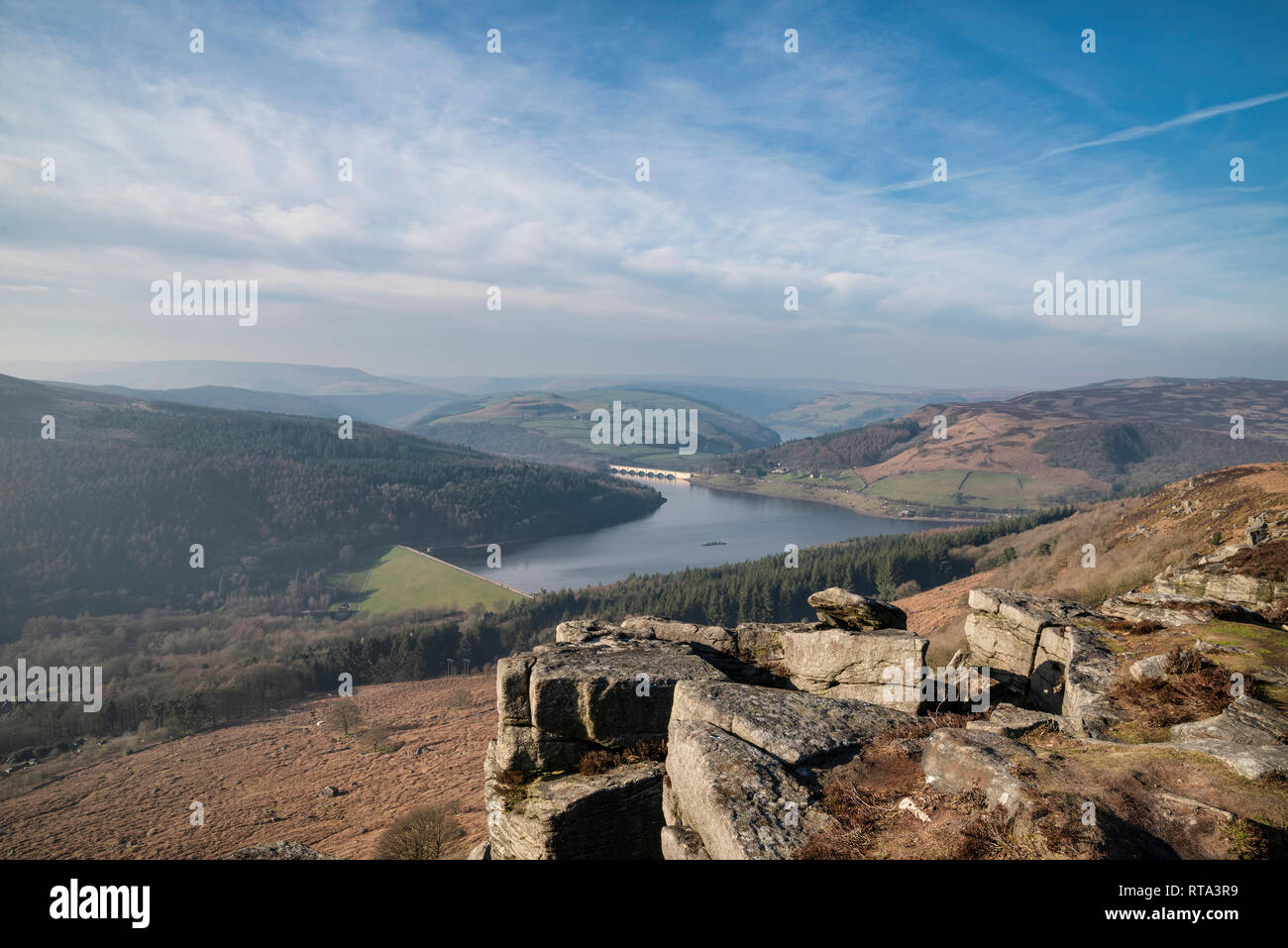 Beautiful landscape image of the Peak District in England viewed from Bamford Edge with Ladybower Reservoir under a beautiful blue Winter sky Stock Photo