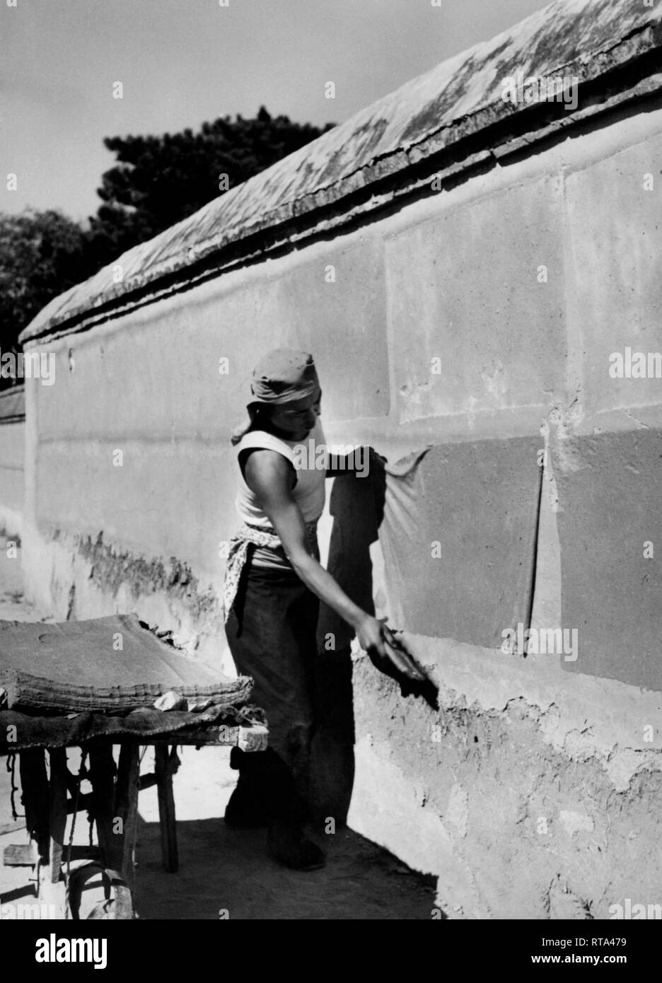 paper recycling, worker spreads sheets of paper on the wall to make ...