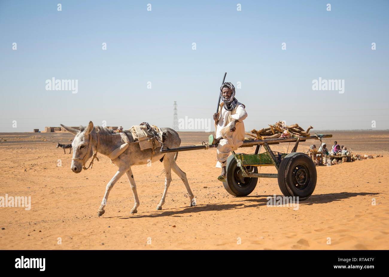 Khartoum, Sudan, 18th December 2015: sudanese man traveling with his donkey in Numibian desert Stock Photo
