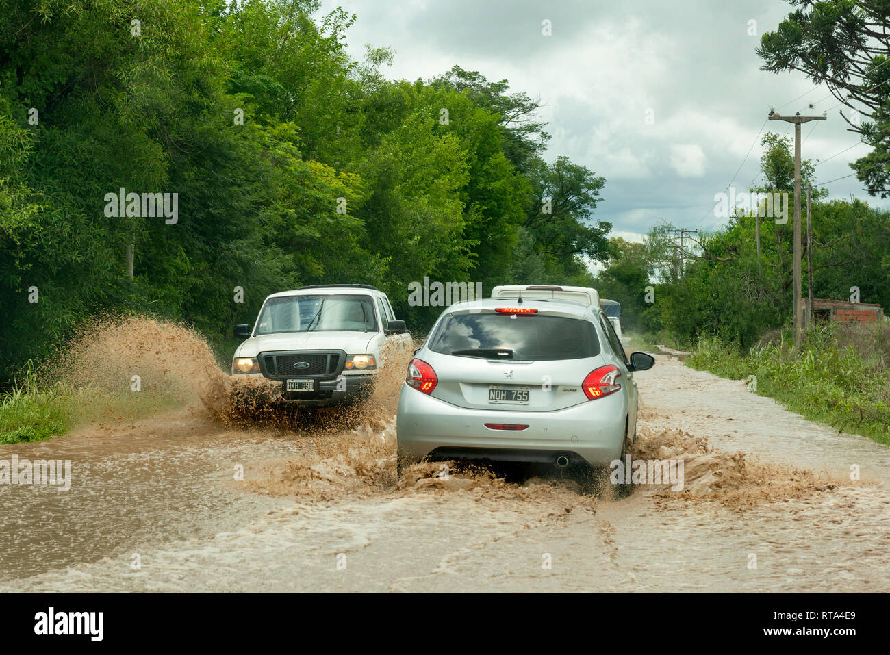 Traffic passing on a flooding affected road near El Carril, Salta Province, Argentina. Stock Photo