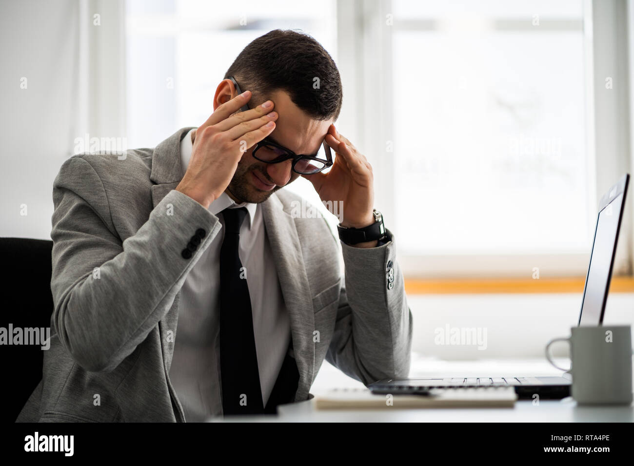 Young businessman is having headache. Stock Photo