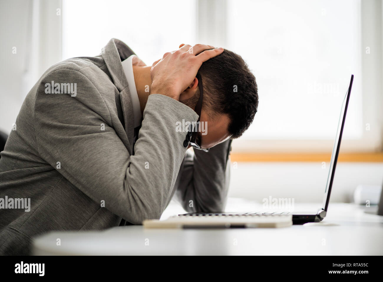 Young businessman is tired of overwork. He is depressed. Stock Photo