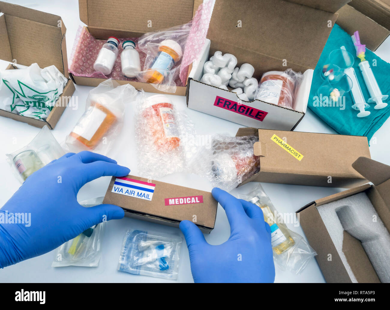 Nurse unpacking medication in boxes, conceptual image, horizontal composition Stock Photo