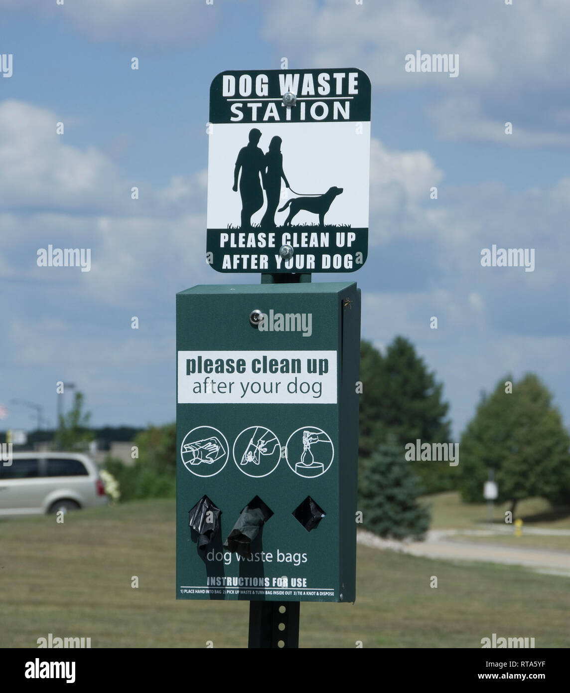 Dog waste station with supply of bags for cleanup in public park Stock