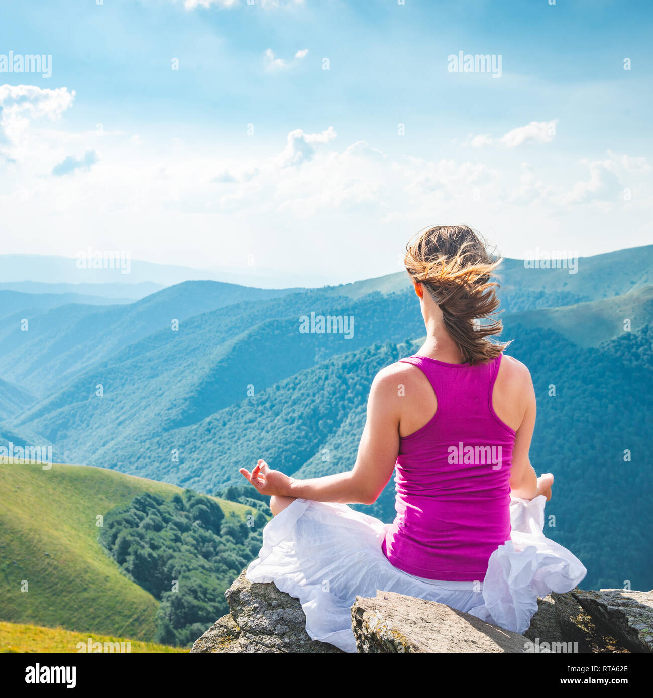 Young woman meditate on the top of mountain Stock Photo - Alamy