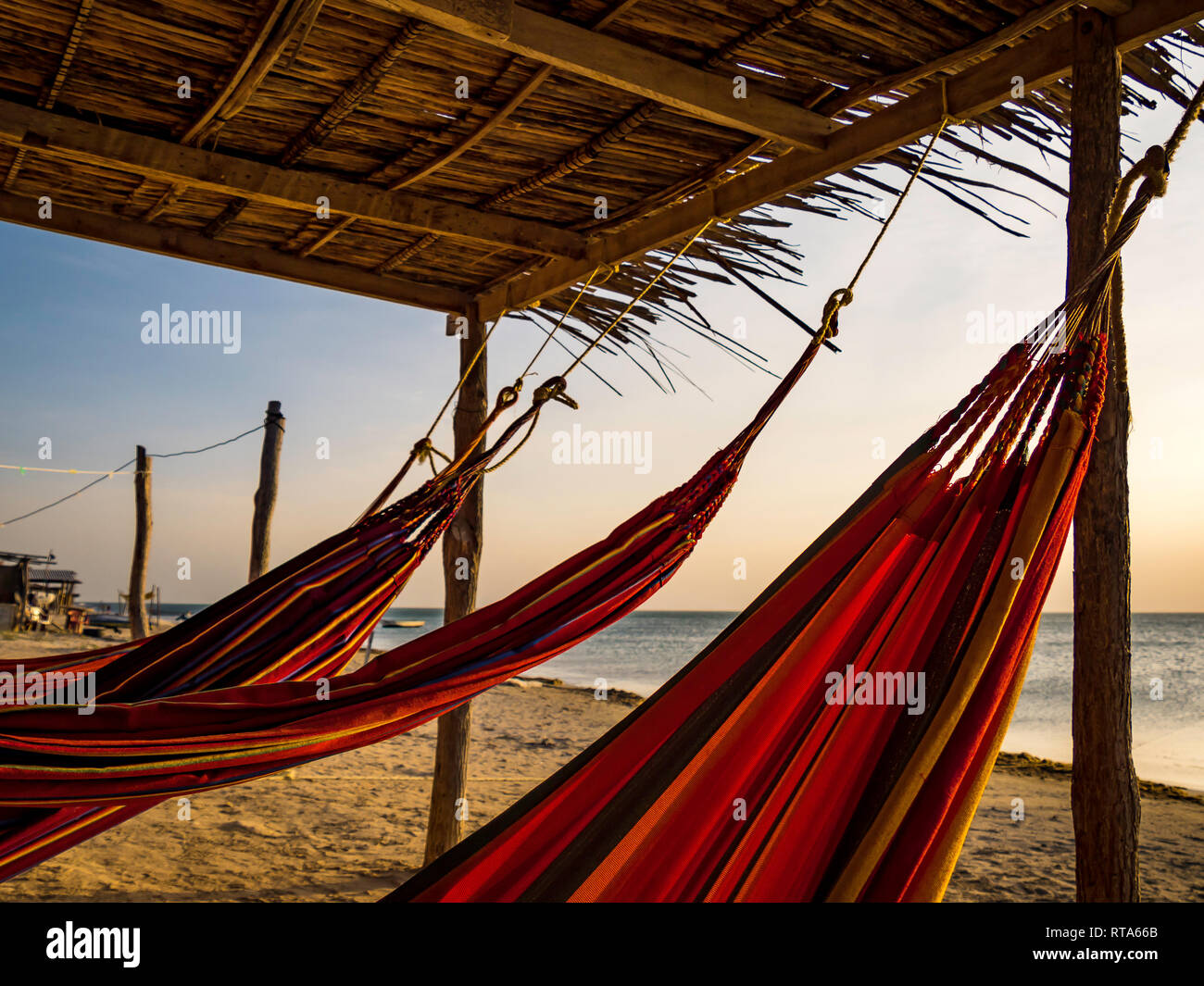 Colorful hammocks in front of the beach in Cabo de la Vela, Colombia Stock Photo