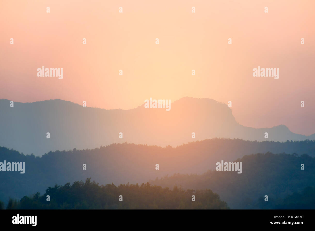 Sunset - sunrise background with layer of mountain Stock Photo - Alamy