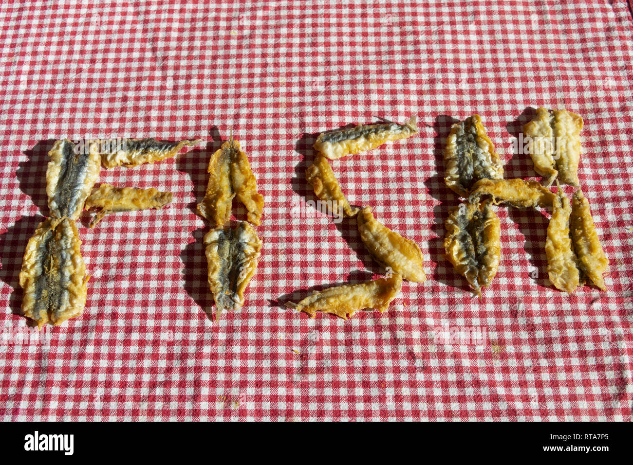 fish word written with fritters of anchovy fillets Stock Photo - Alamy